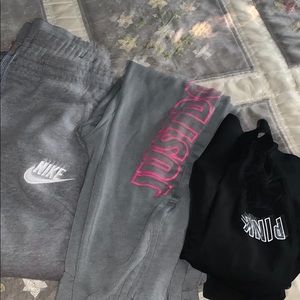 two pairs of Nike sweatpants and pink leggings